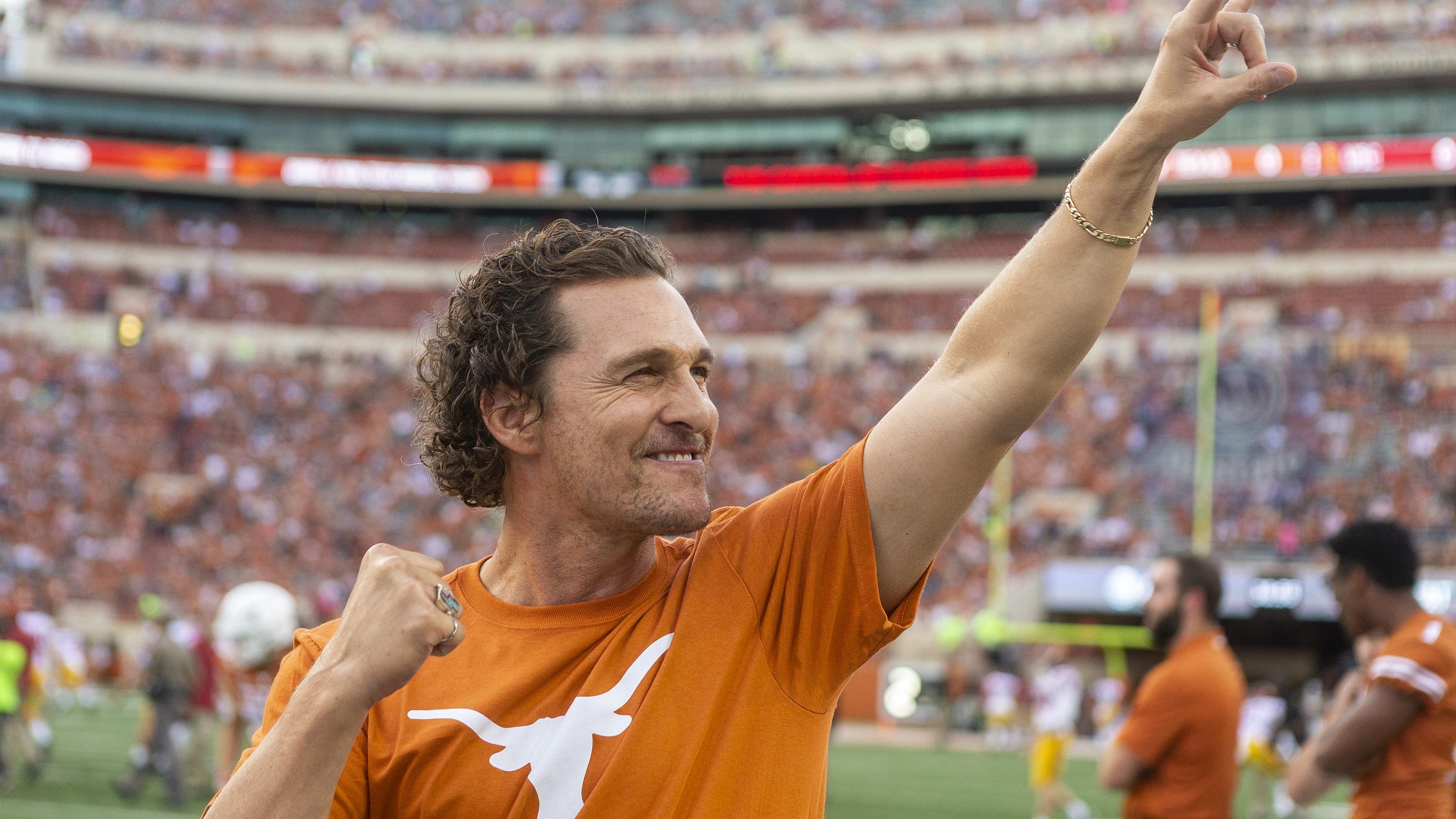 Matthew McConaughey gives the Hook 'Em Horns sign to the crowd before an NCAA football game at Royal-Memorial Stadium, Saturday, Sept. 15, 2018. [Stephen Spillman for Statesman)