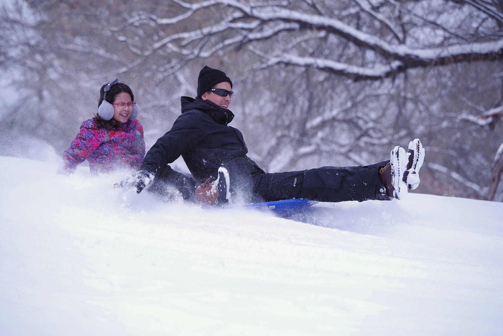 JP Torres and his daughter Autumn go sledding at Memorial Park Sunday morning.