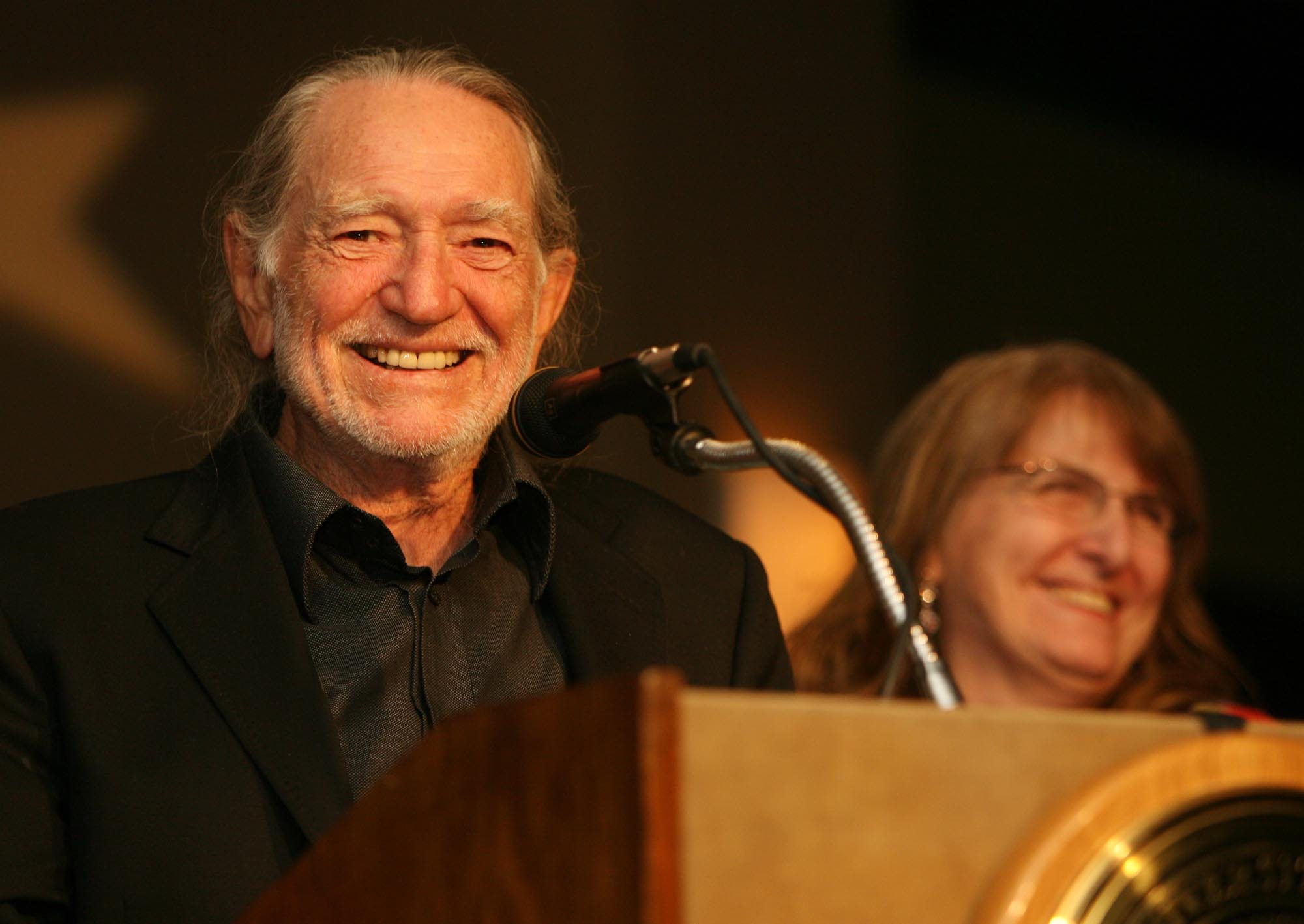 Willie Nelson accepts the Bridging Divides Award from UT's Project on Conflict Resolution given to him by Director Madeline Maxwell, right, at the Frank Erwin Center on Friday Oct. 19, 2007.