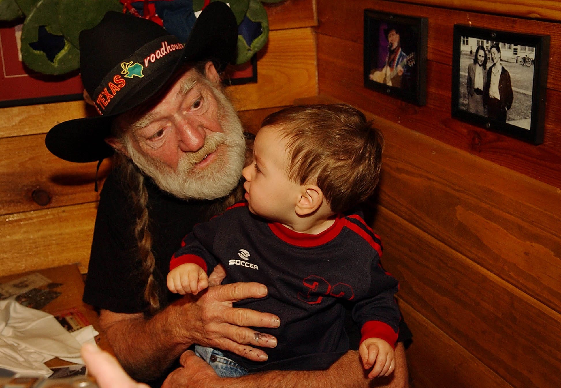 Country music legend Willie Nelson gets to know one-year-old Andrew Dittmar at the grand opening of Nelson's Texas Roadhouse restaurant in Austin on Thursday Dec. 16, 2004.  Andrew's mother, Kimberly Dittmar, won a KVET contest to get to meet Willie Nelson.